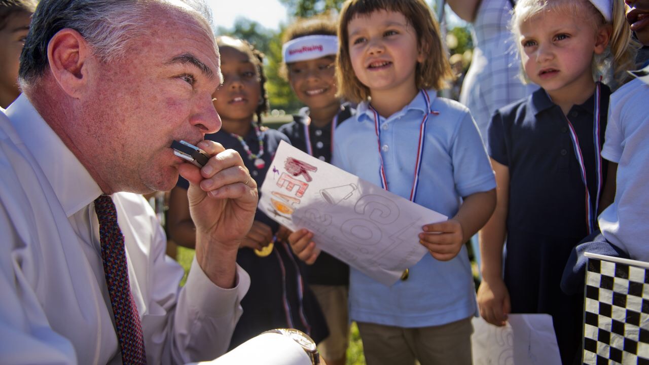 Tim Kaine playing the harmonica for some kids